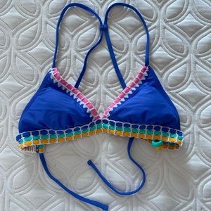 Blue bikini top with pink green and yellow detailing lacing.